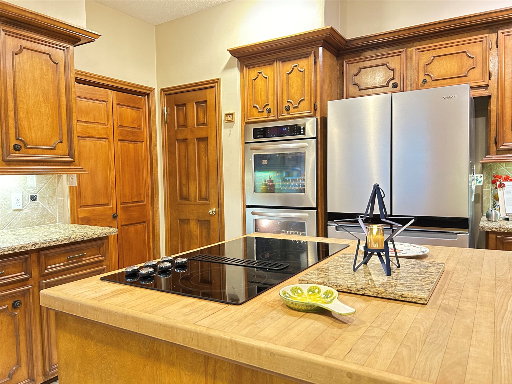 9547 Enstone Circle Spring, TX 77379 - Photo 14 of 45 a kitchen with stainless steel appliances granite countertop a sink and a refrigerator