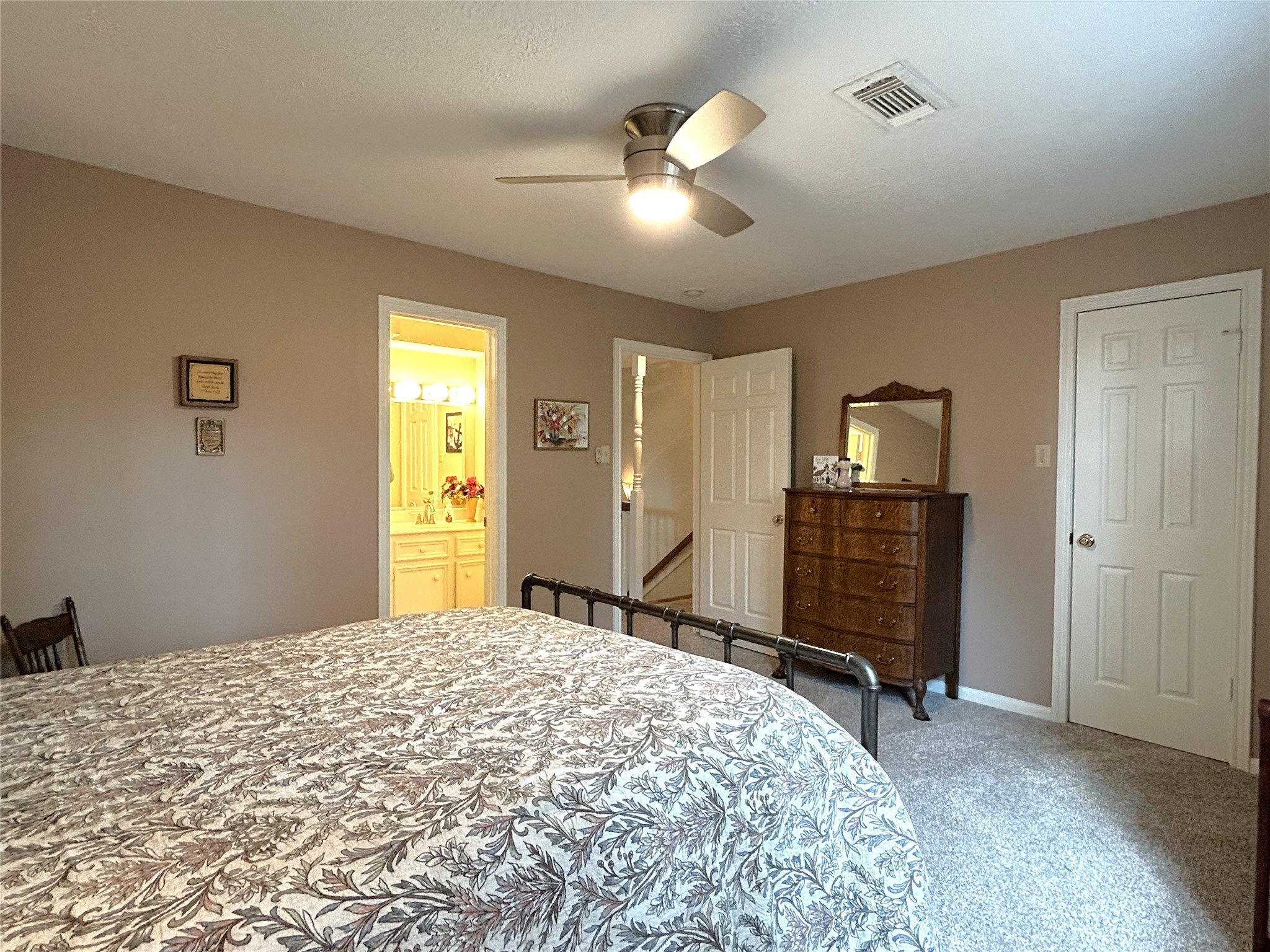 9547 Enstone Circle Spring, TX 77379 - Photo 29 of 45 a bedroom with a bed and a chandelier
