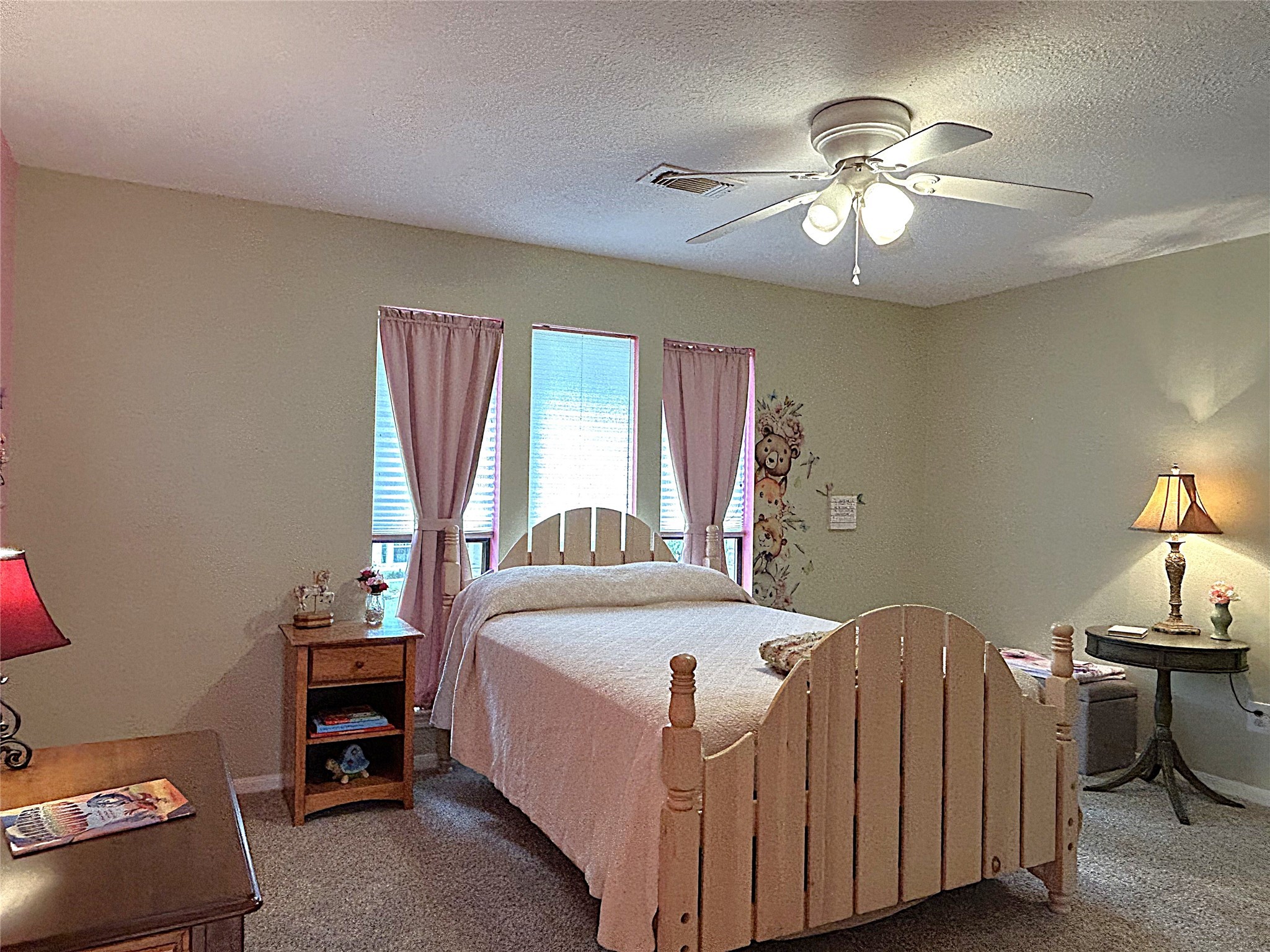 9547 Enstone Circle Spring, TX 77379 - Photo 38 of 45 a bedroom with a bed and a chandelier