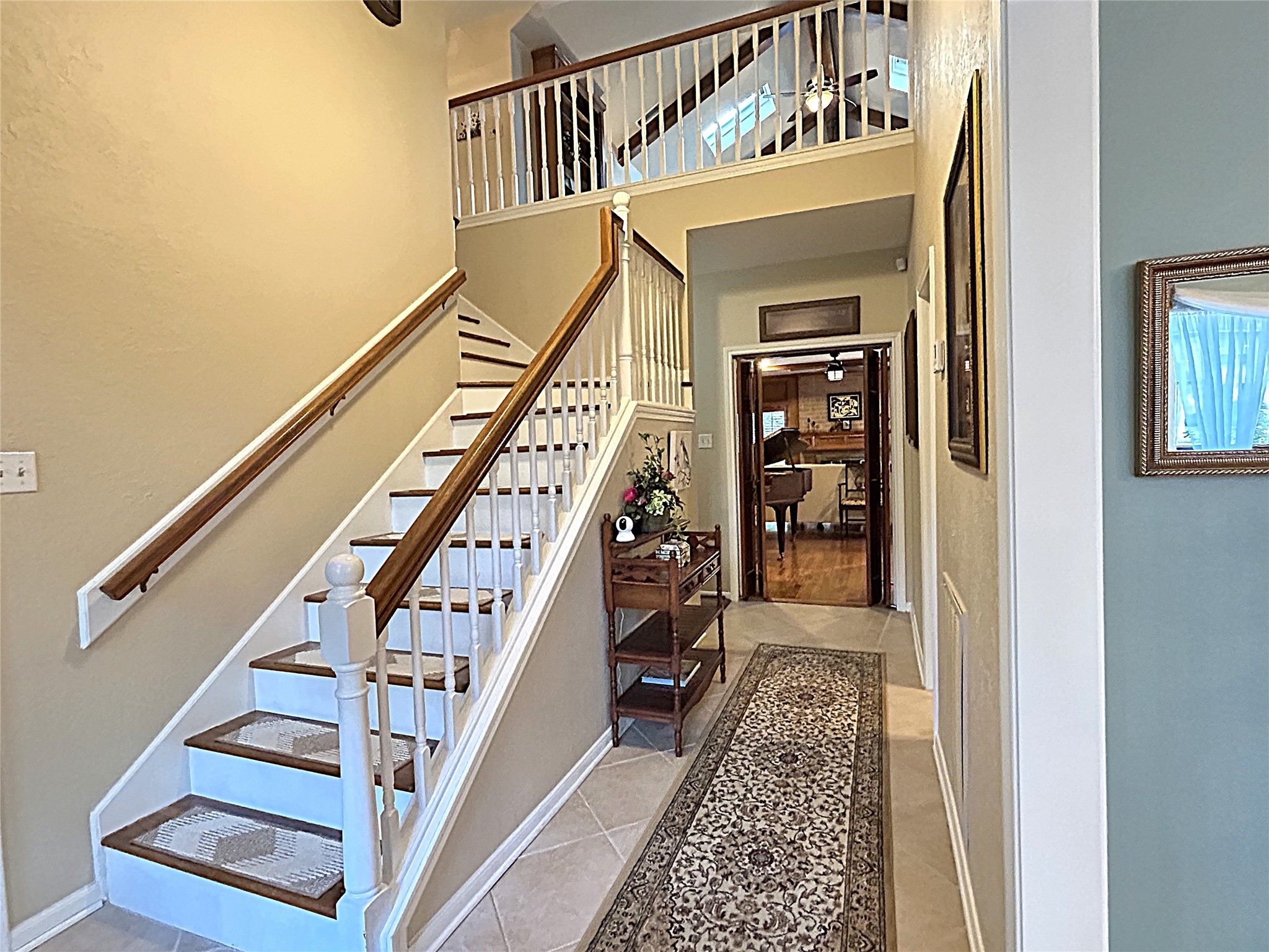 9547 Enstone Circle Spring, TX 77379 - Photo 5 of 45 a view of staircase with wooden floor and a rug