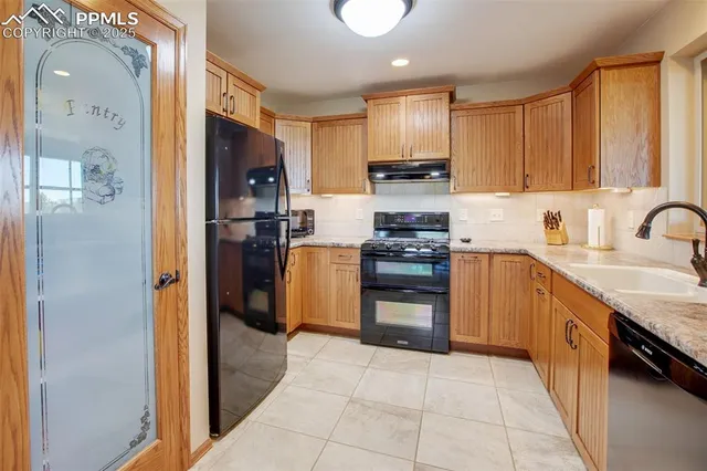 a kitchen with refrigerator and cabinets