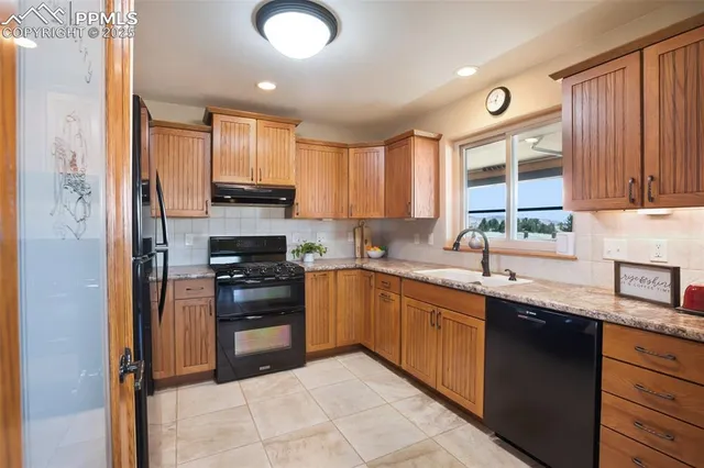a kitchen with stainless steel appliances granite countertop a stove sink and cabinets