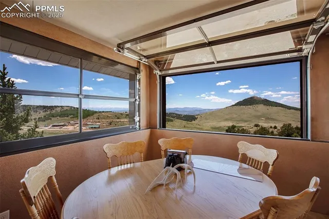 a view of a living room and dining room with furniture window and outside view