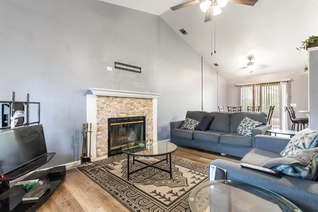 a living room with furniture a flat screen tv and a fireplace