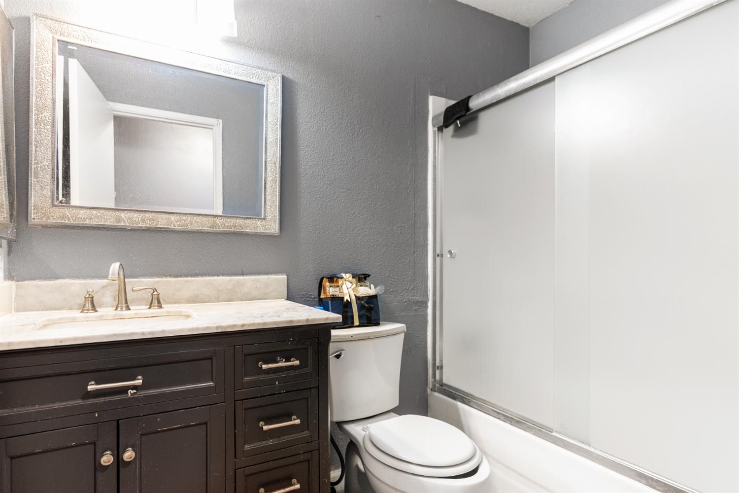 600 Sears Drive Patterson, CA 95363 - Photo 26 of 44 a bathroom with a sink vanity mirror and toilet