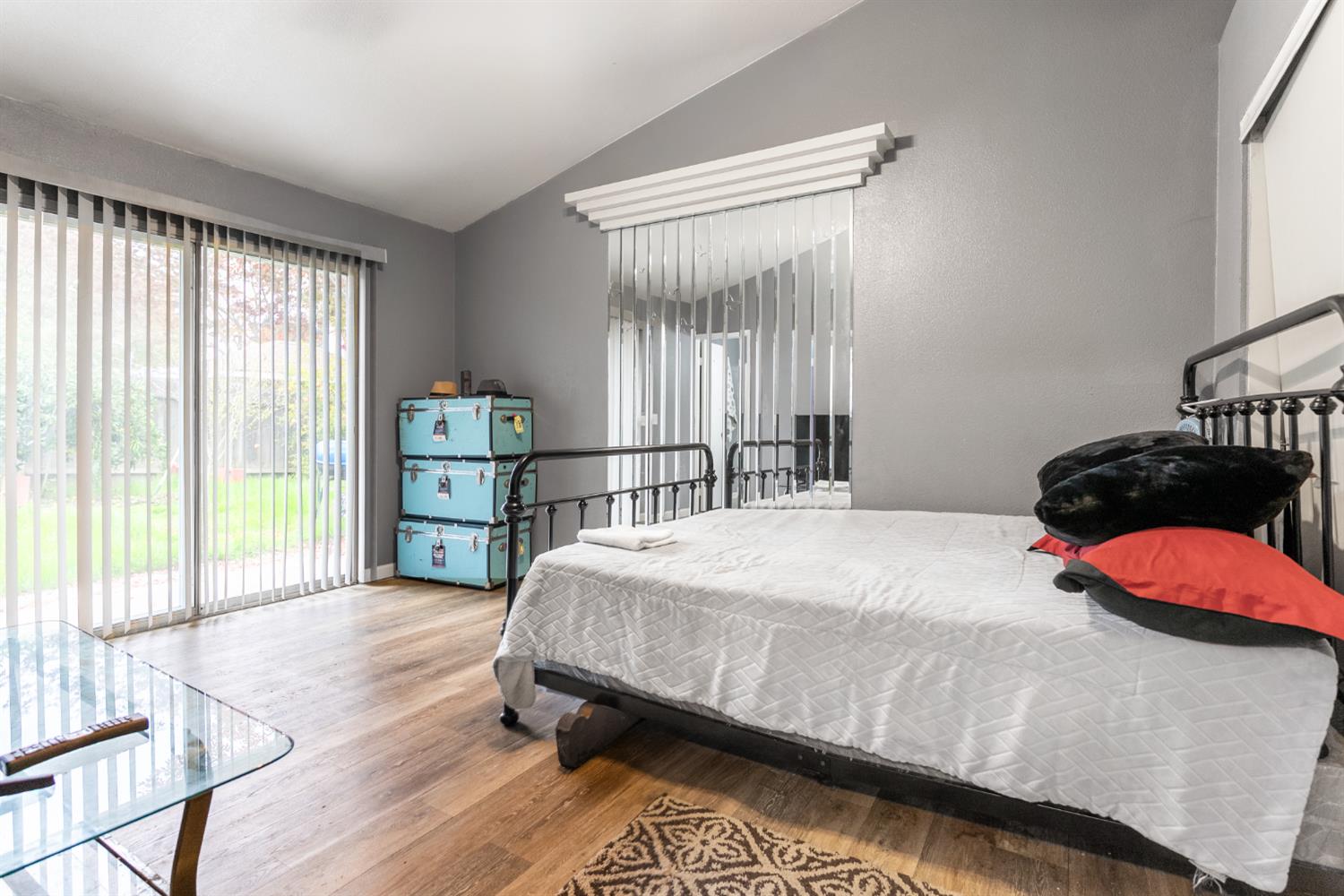 600 Sears Drive Patterson, CA 95363 - Photo 31 of 44 a bedroom with a bed and large window with wooden floor