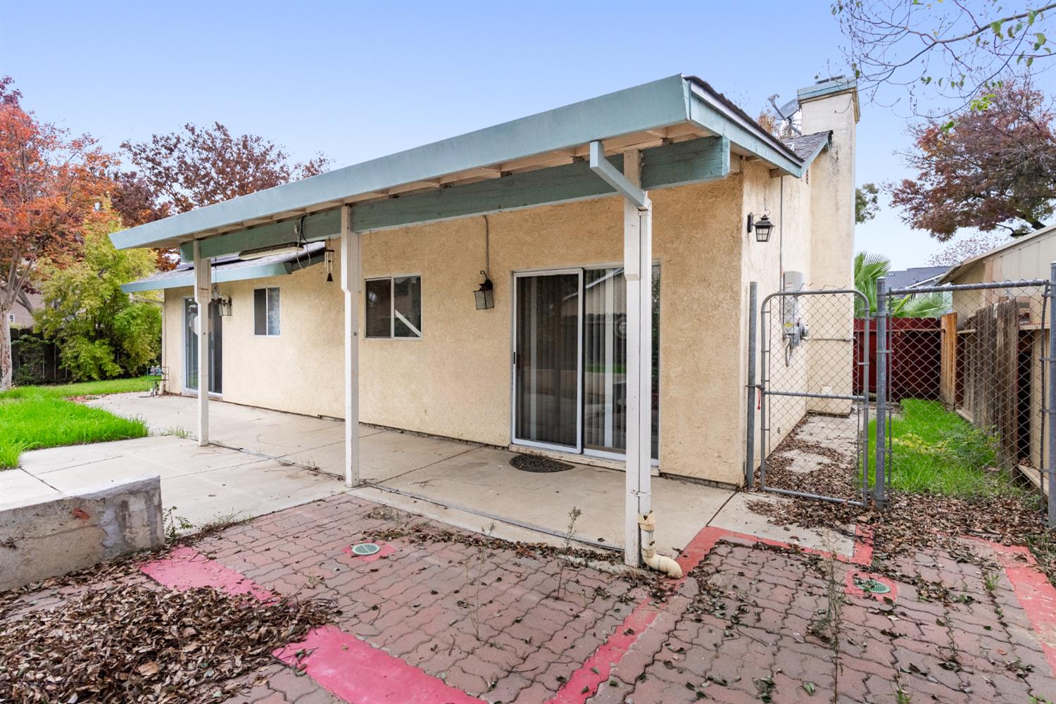600 Sears Drive Patterson, CA 95363 - Photo 43 of 44 a backyard of a house with wooden fence and a toy car