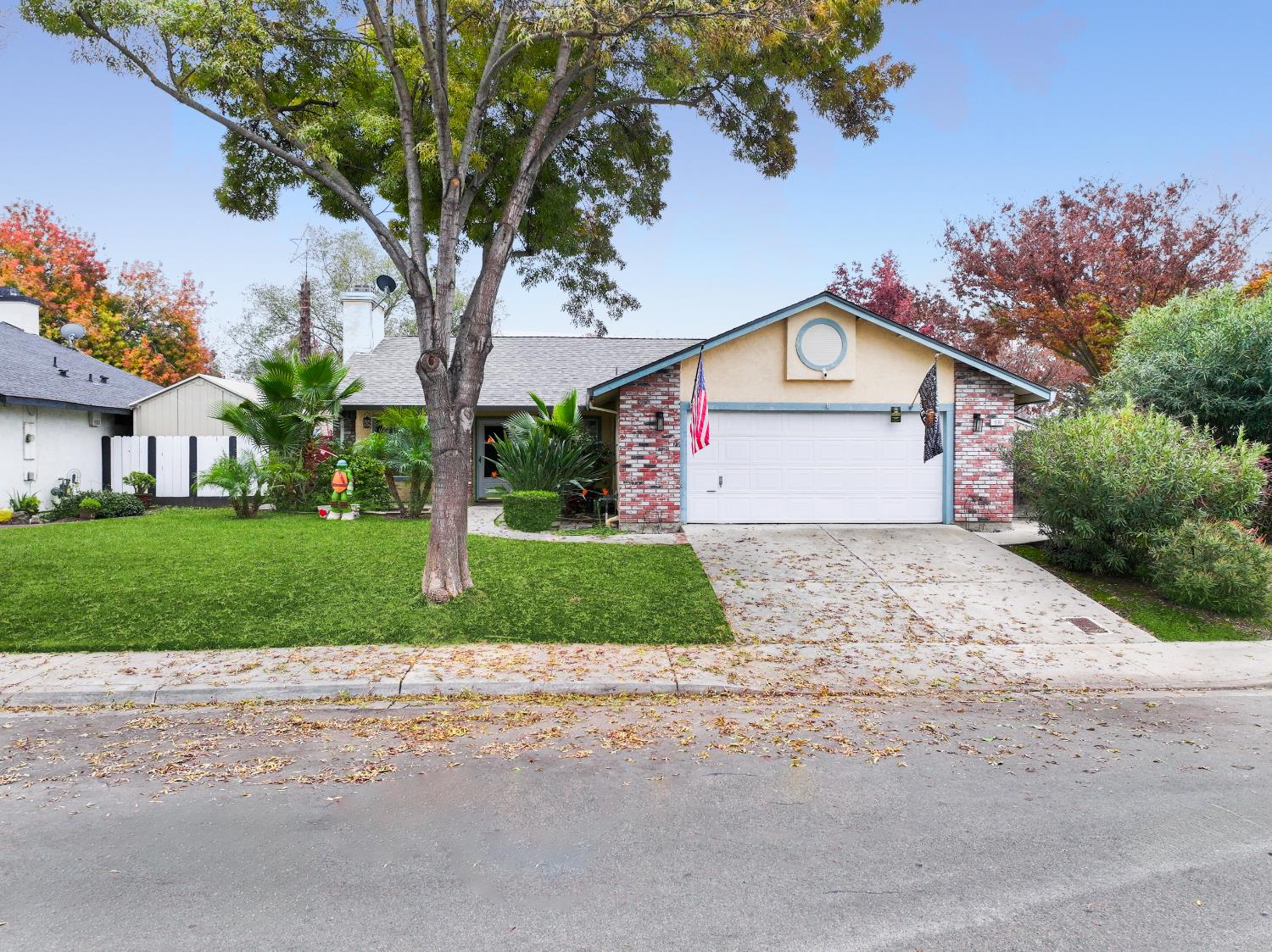 600 Sears Drive Patterson, CA 95363 - Photo 5 of 44 a front view of a house with a yard and garage