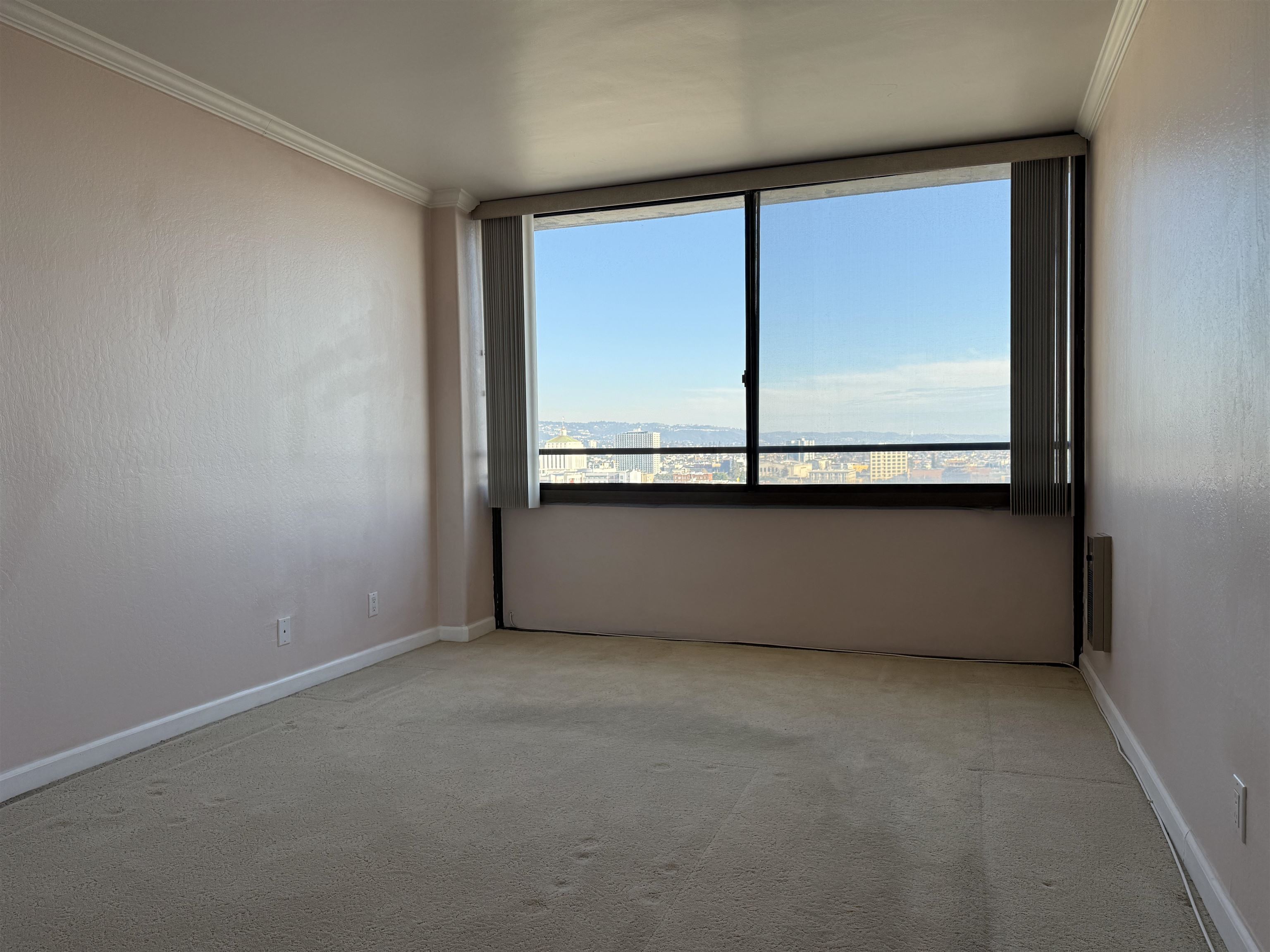 801 Franklin Street, Unit 1239 Oakland, CA 94607 - Photo 11 of 15 Empty room with crown molding and light carpet