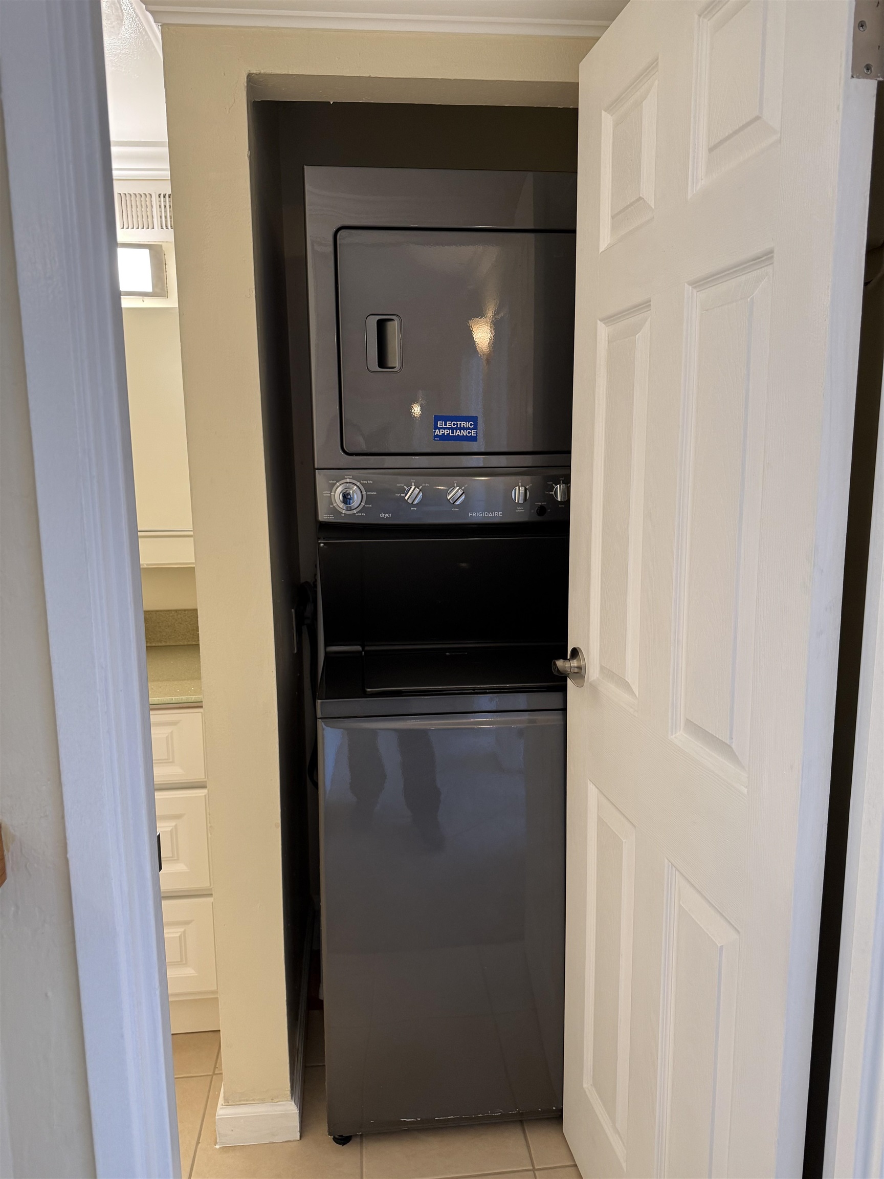 801 Franklin Street, Unit 1239 Oakland, CA 94607 - Photo 14 of 15 Laundry area featuring light tile patterned floors and stacked washer / drying machine
