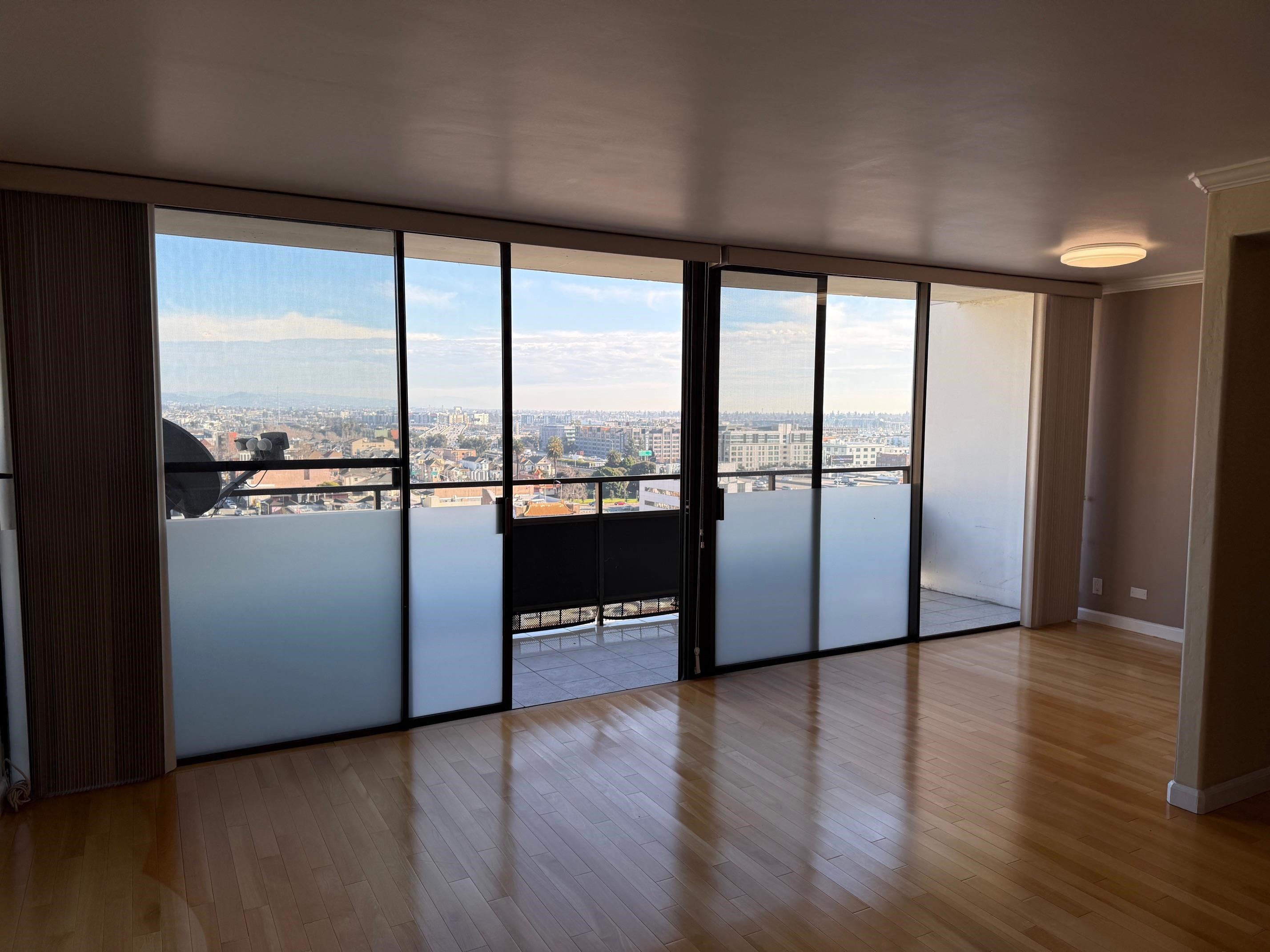 801 Franklin Street, Unit 1239 Oakland, CA 94607 - Photo 3 of 15 Entry with a city view, floor to ceiling windows, light wood-style flooring, and crown molding
