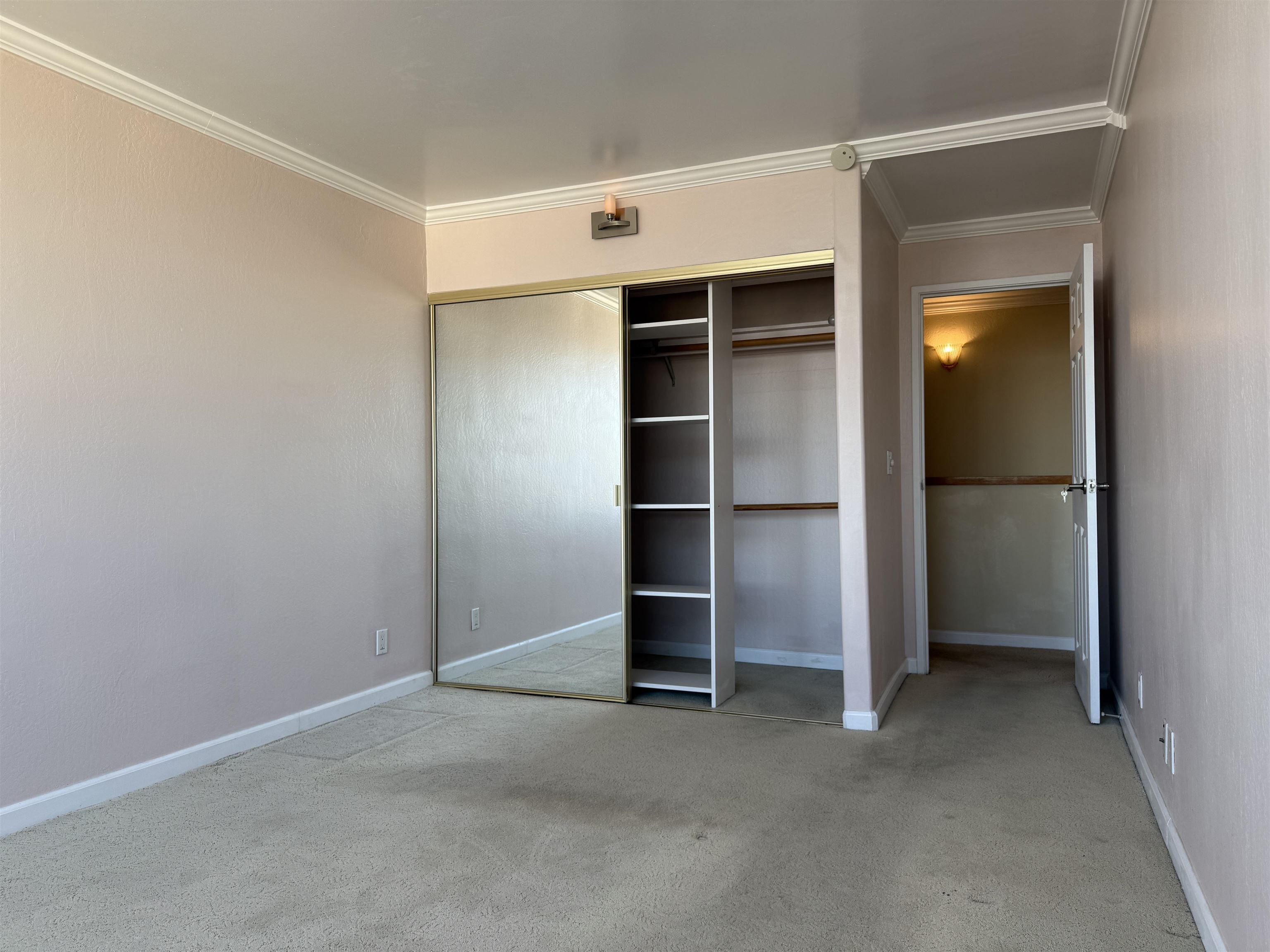 801 Franklin Street, Unit 1239 Oakland, CA 94607 - Photo 10 of 15 Unfurnished bedroom featuring crown molding, light colored carpet, and a closet