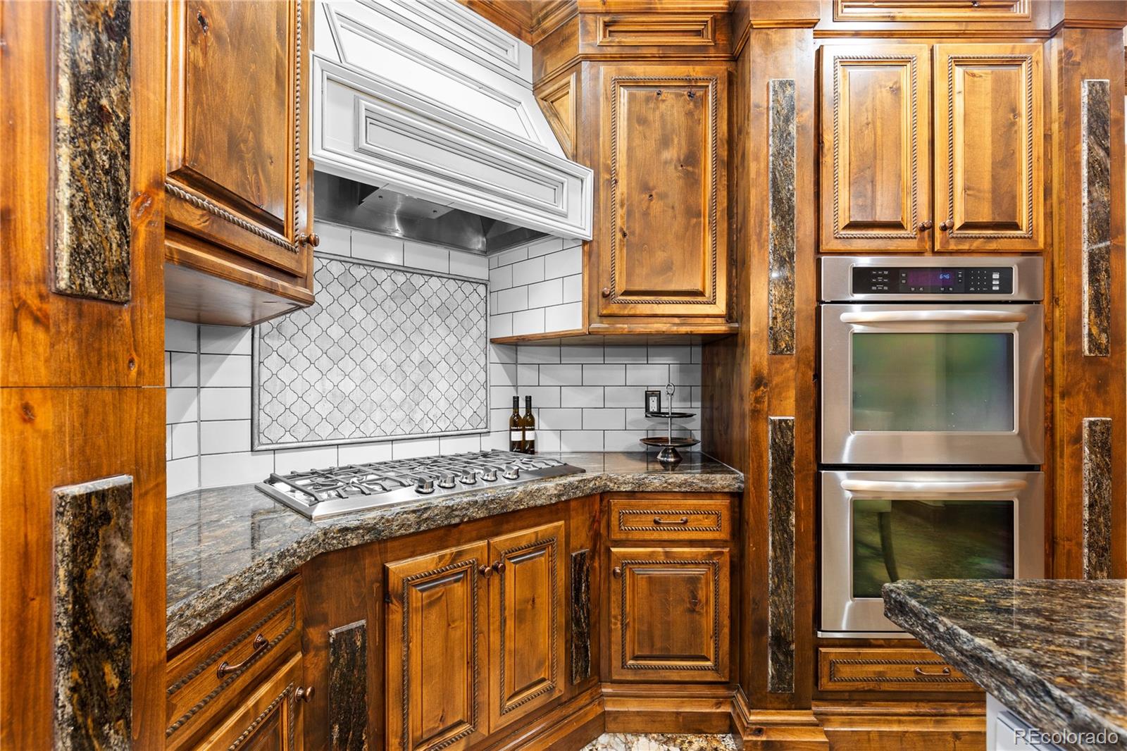 100 Halter Way Evergreen, CO 80439 - Photo 14 of 40 a kitchen with stainless steel appliances granite countertop a stove and a refrigerator