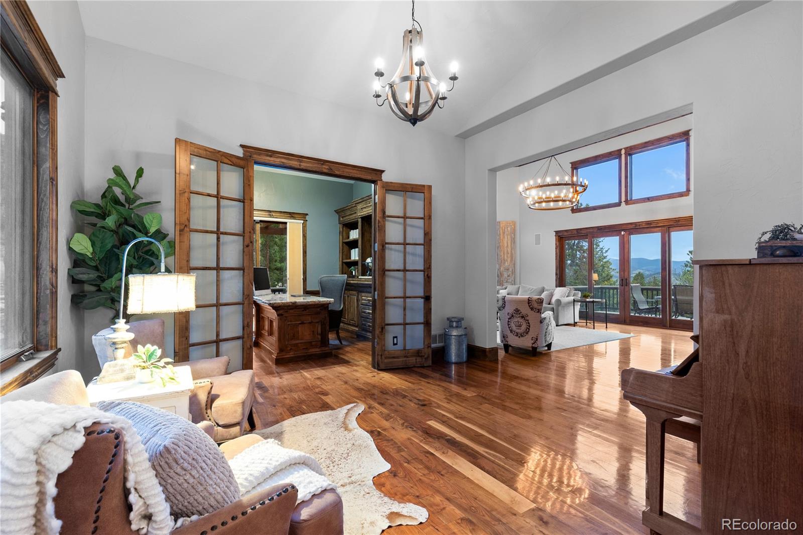 100 Halter Way Evergreen, CO 80439 - Photo 18 of 40 a living room with furniture large window and wooden floor
