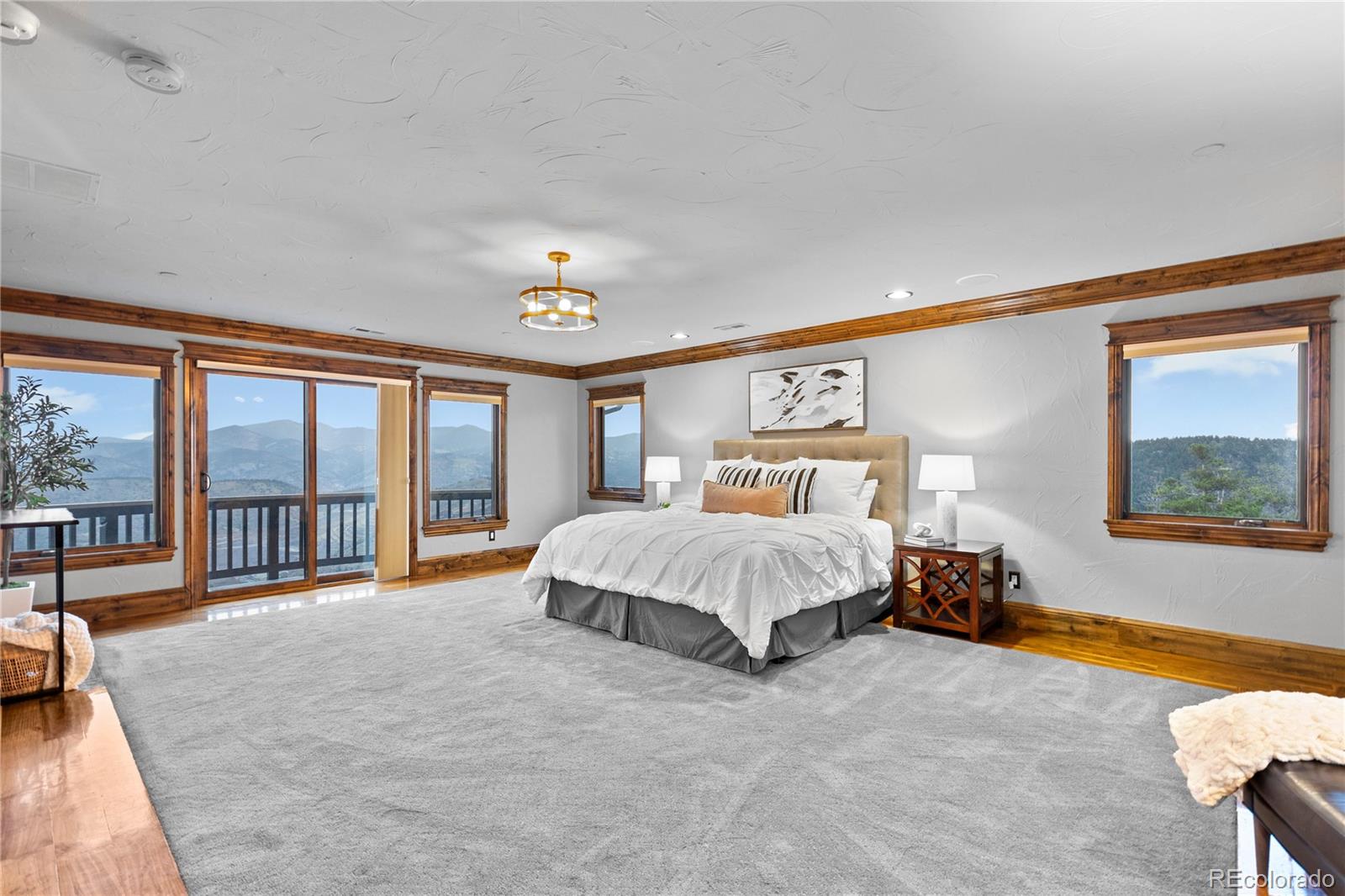 100 Halter Way Evergreen, CO 80439 - Photo 21 of 40 a spacious bedroom with a bed and a large window