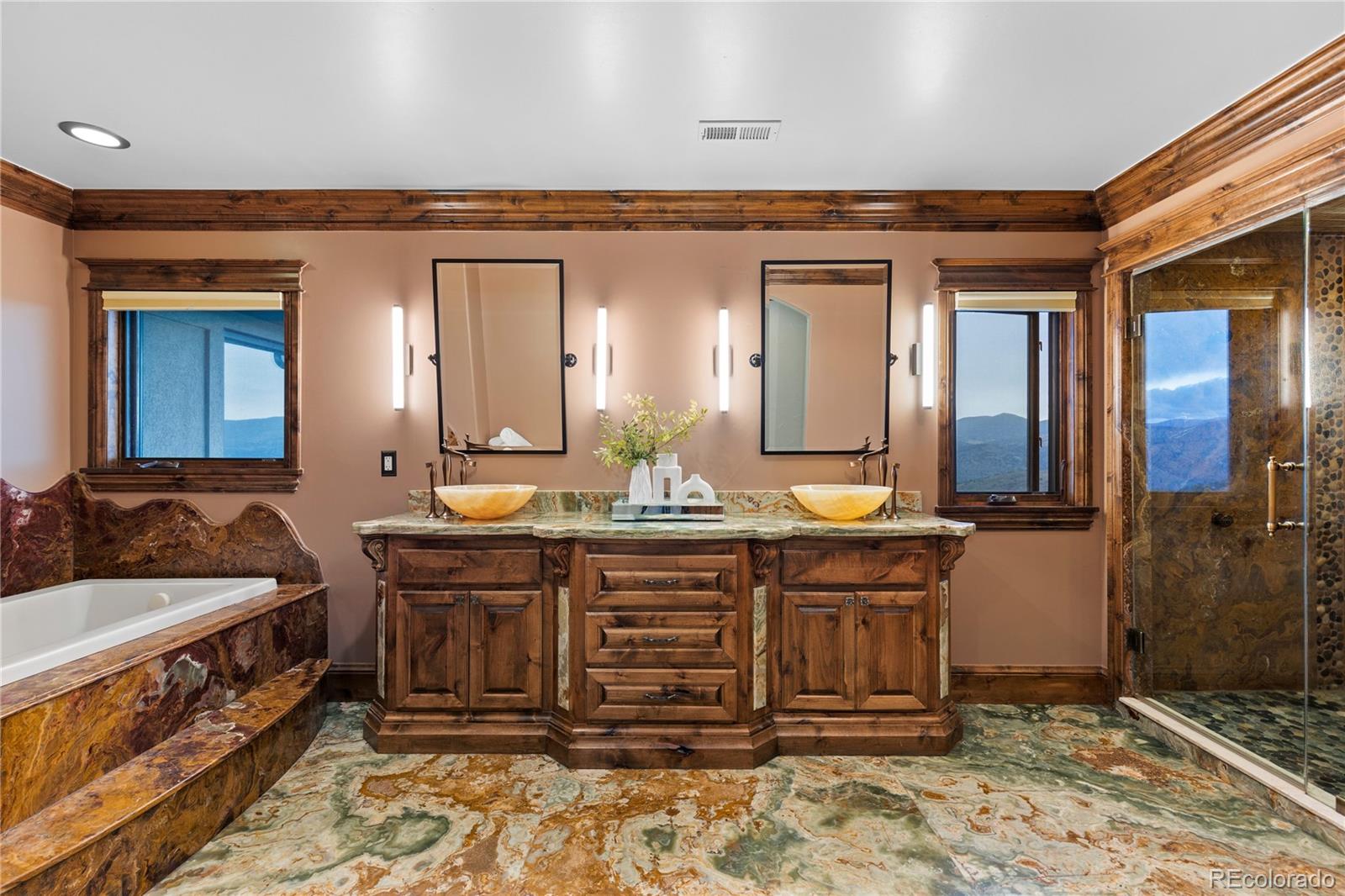 100 Halter Way Evergreen, CO 80439 - Photo 22 of 40 a spacious bathroom with a tub a sink and a mirror