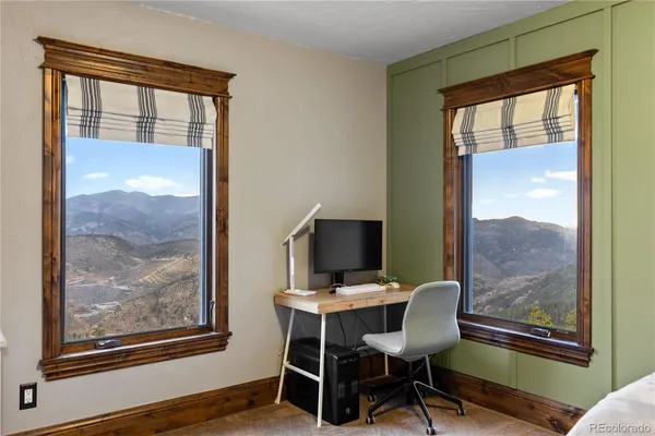 a view of a dining room with furniture and a window