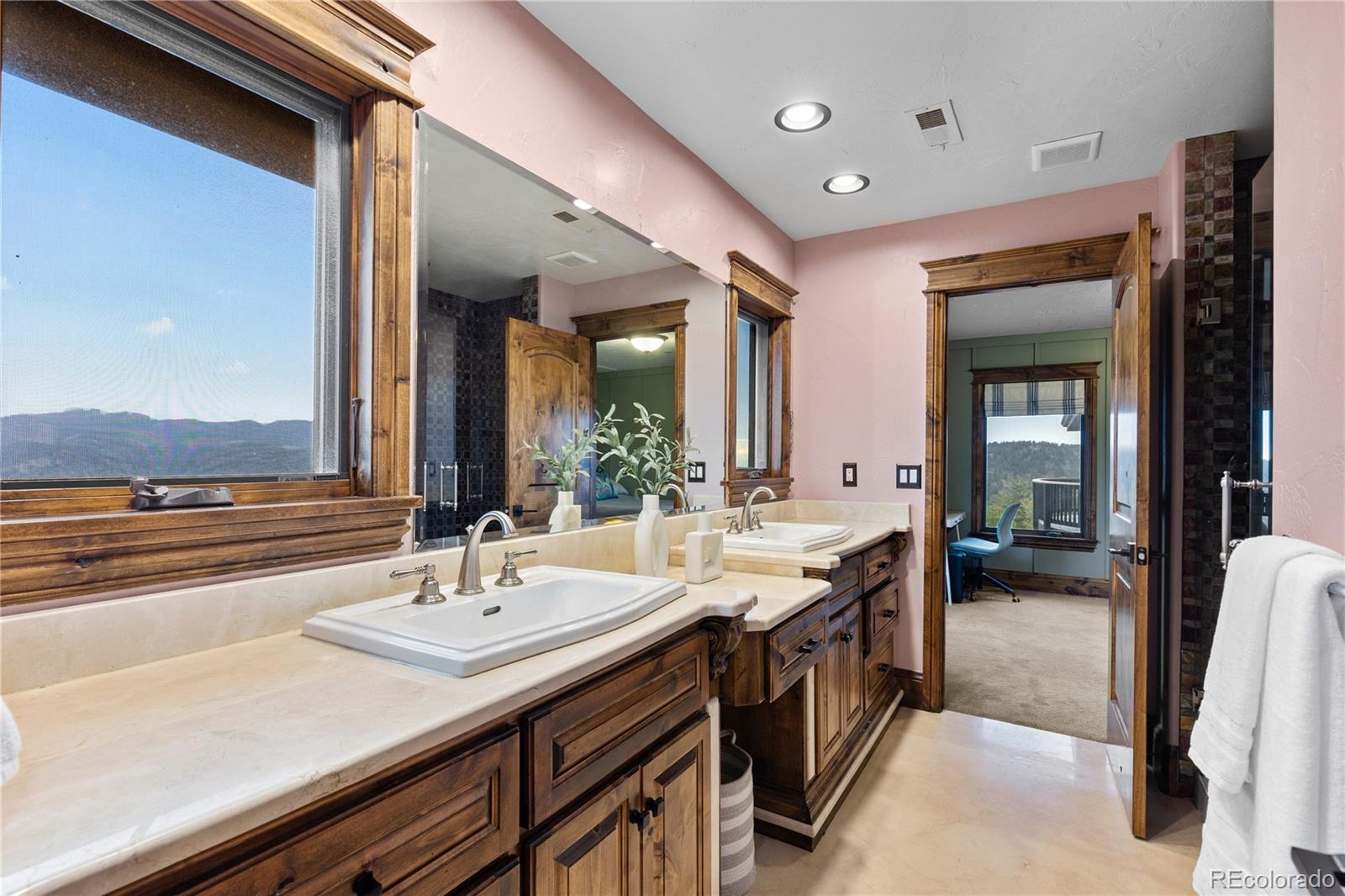 100 Halter Way Evergreen, CO 80439 - Photo 26 of 40 a bathroom with a sink double vanity and a mirror