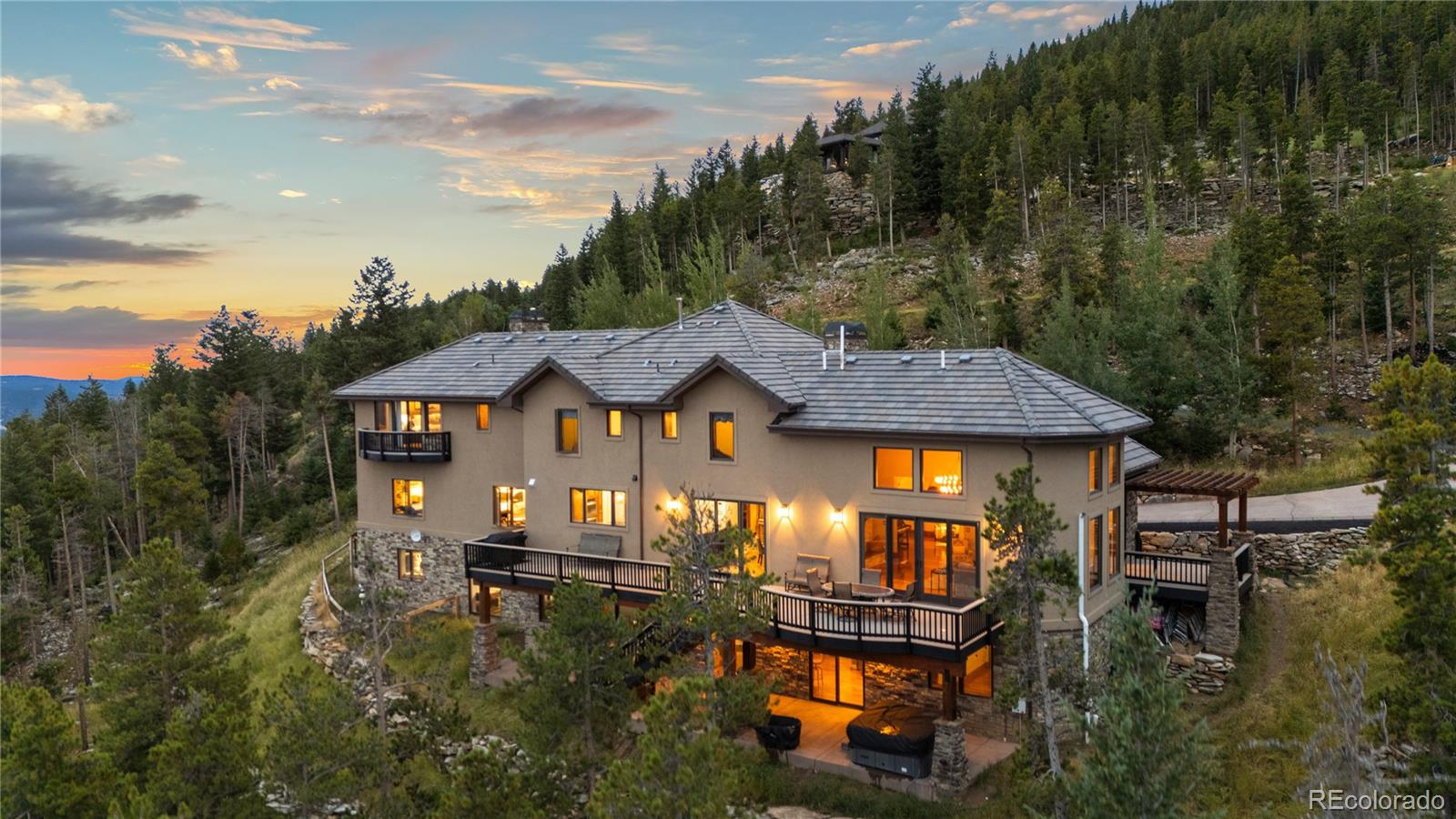 100 Halter Way Evergreen, CO 80439 - Photo 5 of 40 aerial view of a house with balcony and trees al around