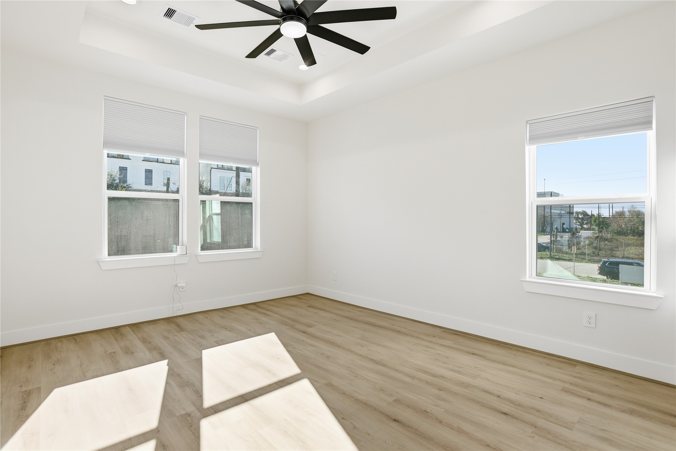 712 Delano Street, Unit A Houston, TX 77003 - Photo 13 of 35 a view of a big room with wooden floor and windows