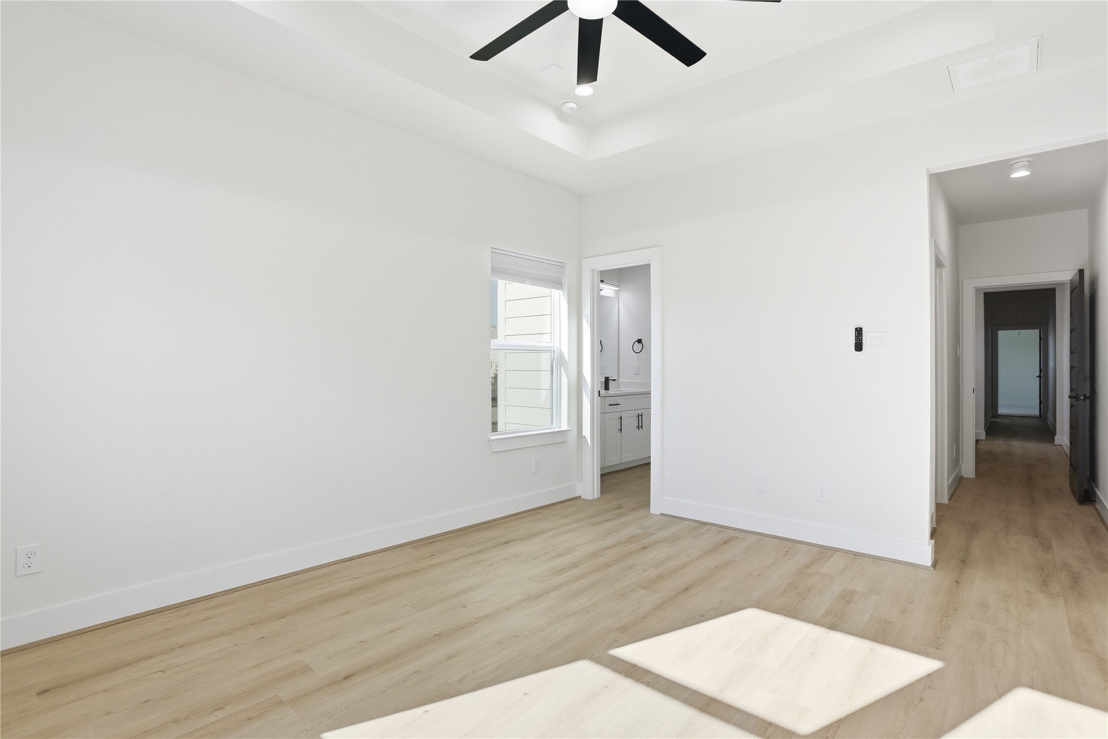 712 Delano Street, Unit A Houston, TX 77003 - Photo 14 of 35 an empty room with wooden floor and ceiling fan