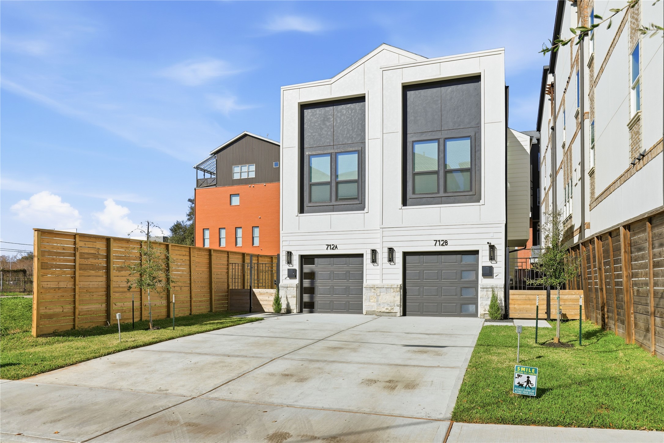 712 Delano Street, Unit A Houston, TX 77003 - Photo 34 of 35 a front view of a house with a yard and garage