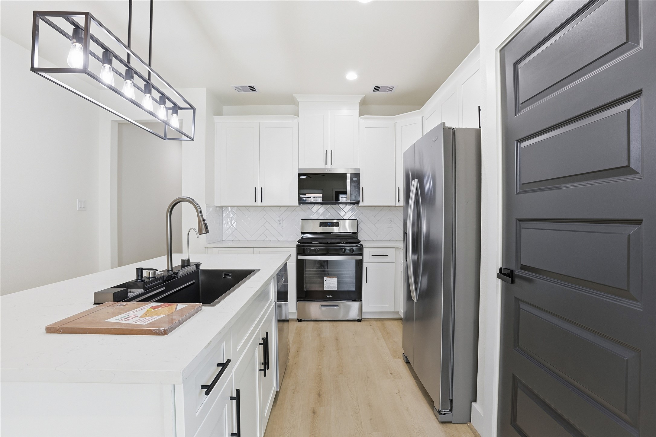 712 Delano Street, Unit A Houston, TX 77003 - Photo 7 of 35 a kitchen with stainless steel appliances granite countertop a sink stove and refrigerator