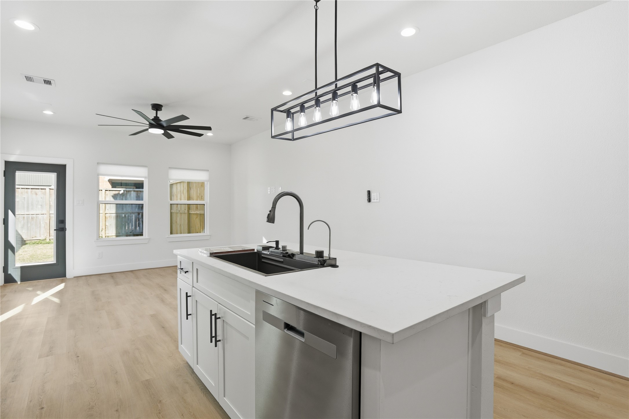 712 Delano Street, Unit A Houston, TX 77003 - Photo 8 of 35 a kitchen with stainless steel appliances a sink and a chandelier