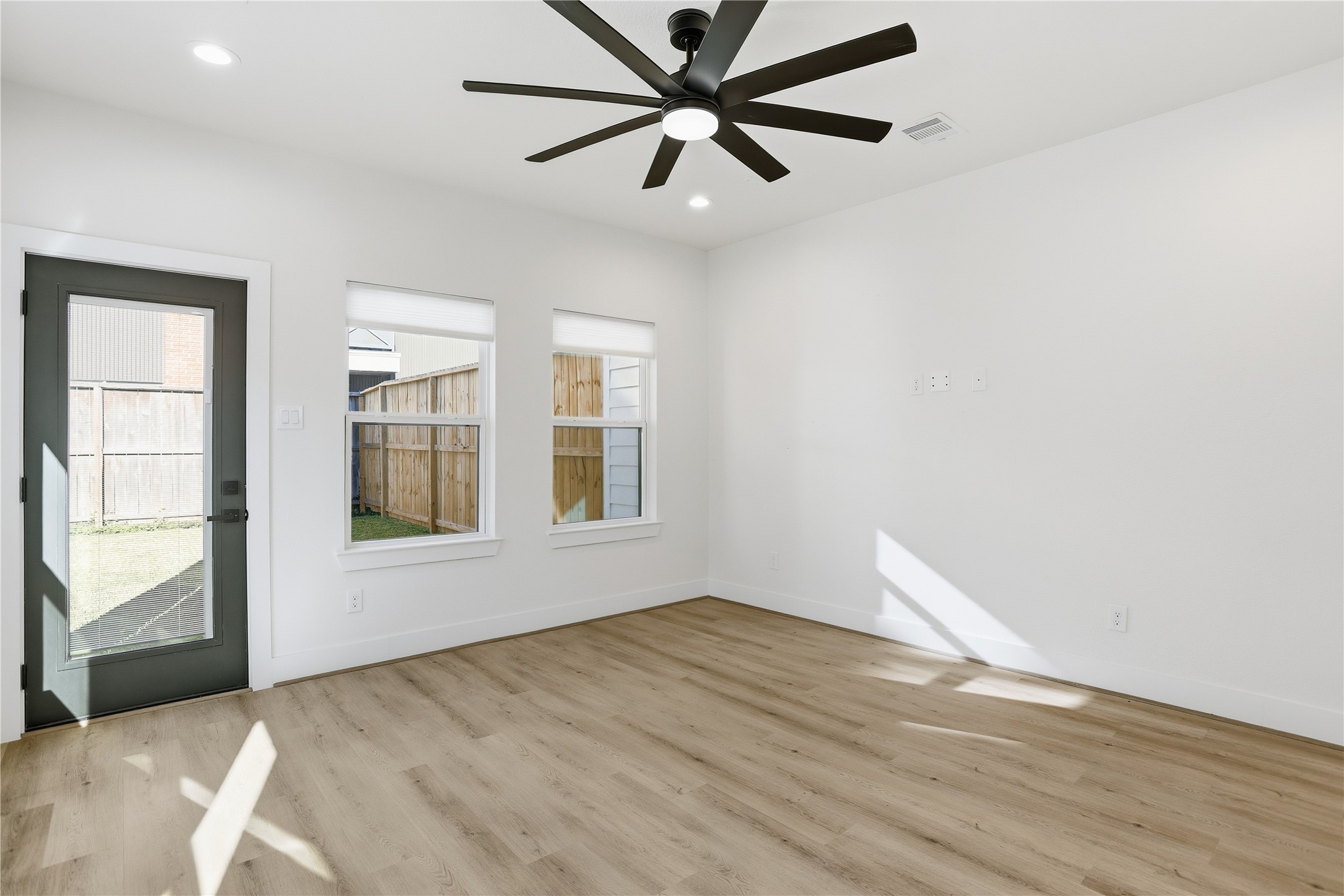 712 Delano Street, Unit A Houston, TX 77003 - Photo 9 of 35 wooden floor in an empty room with a window