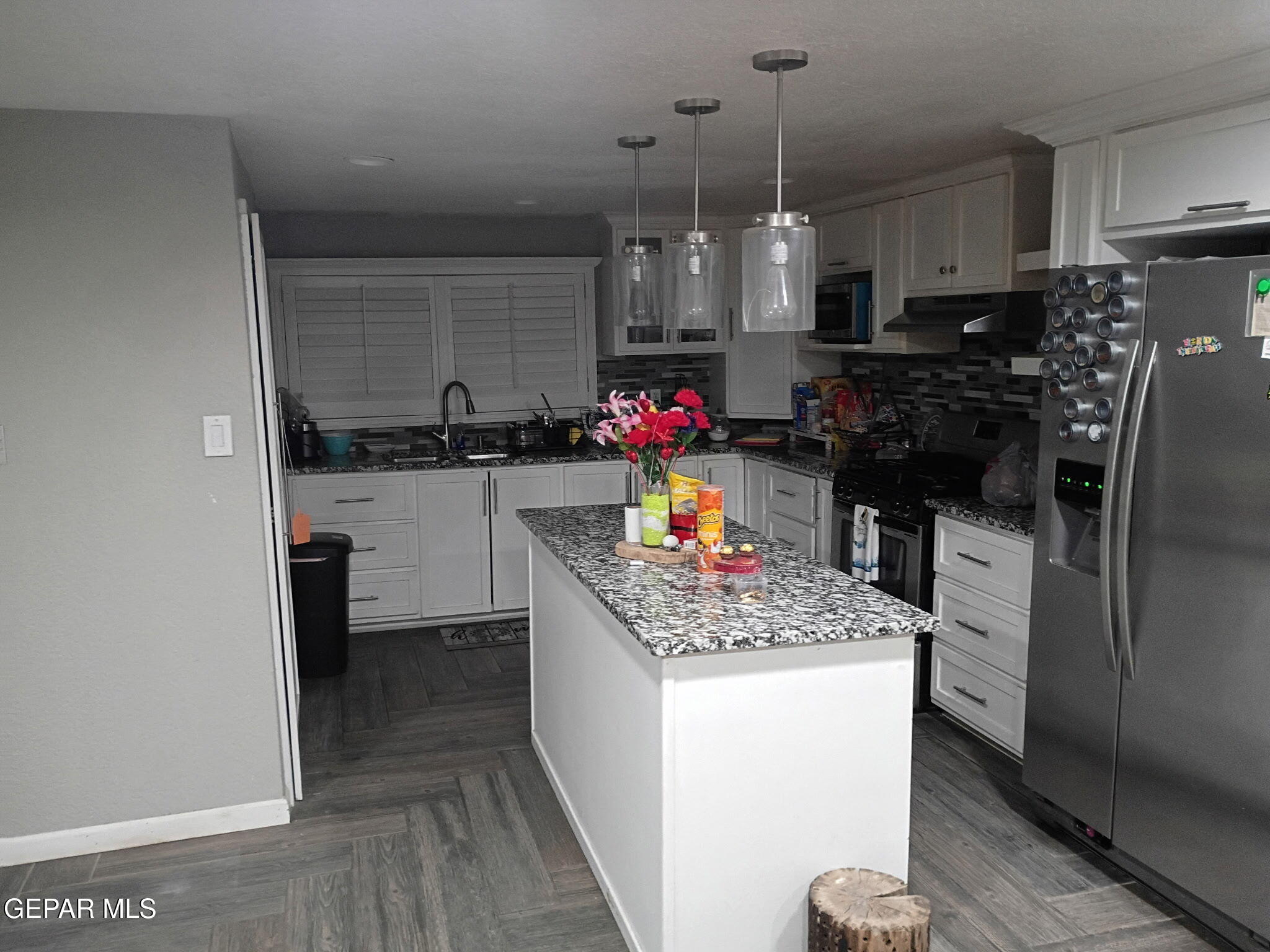 225 Polo Inn Road El Paso, TX 79915 - Photo 2 of 12 a kitchen with stainless steel appliances granite countertop a sink stove and refrigerator