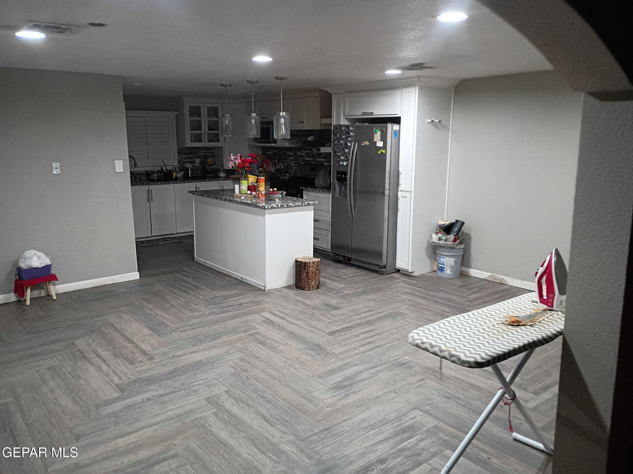 225 Polo Inn Road El Paso, TX 79915 - Photo 3 of 12 a kitchen with stainless steel appliances kitchen island granite countertop a refrigerator and a sink