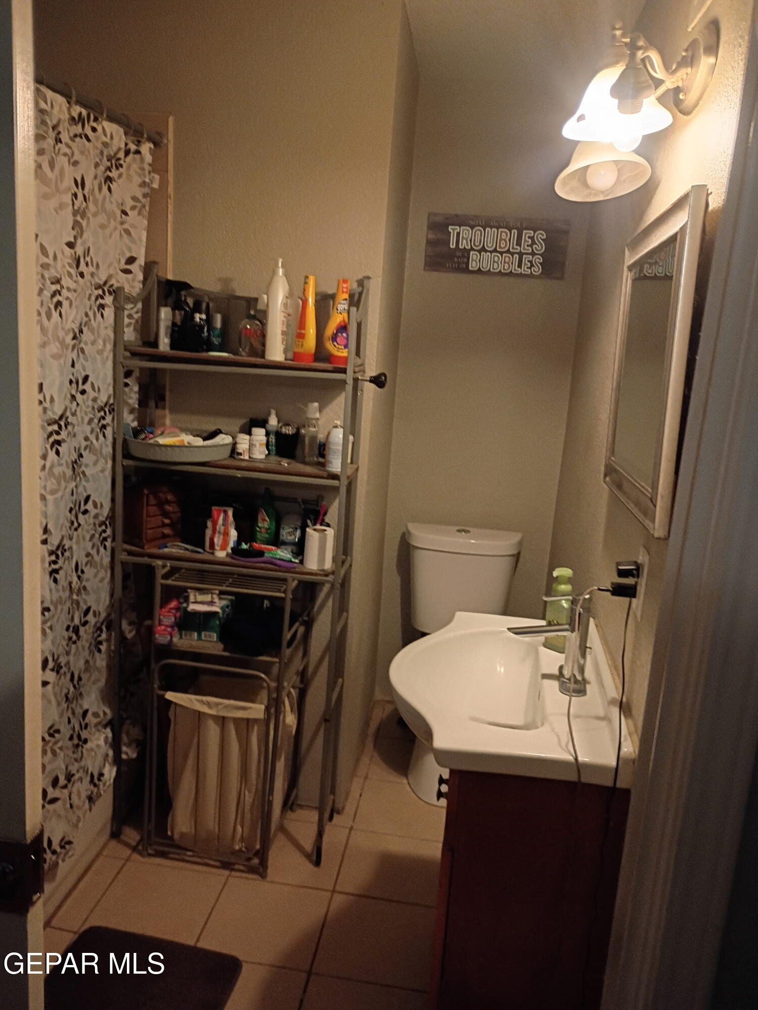 225 Polo Inn Road El Paso, TX 79915 - Photo 4 of 12 a bathroom with a sink and a mirror