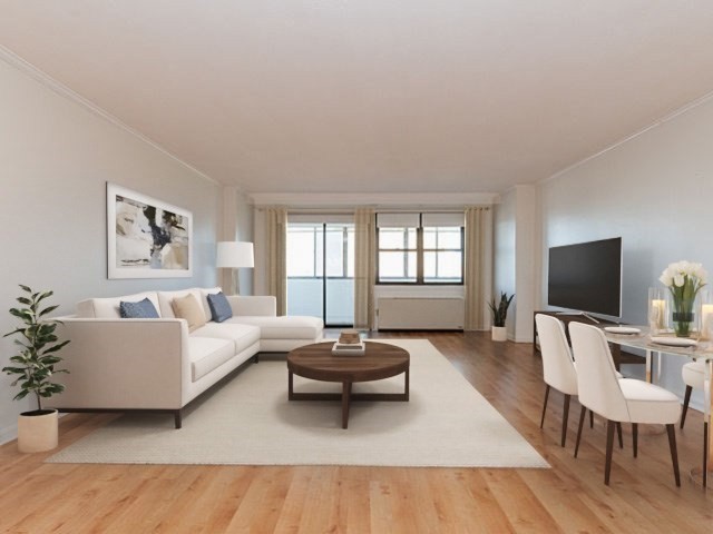 6 Whittier Place, Unit 9E Boston, MA 02114 - Photo 1 of 24 a living room with furniture a large window and a flat screen tv