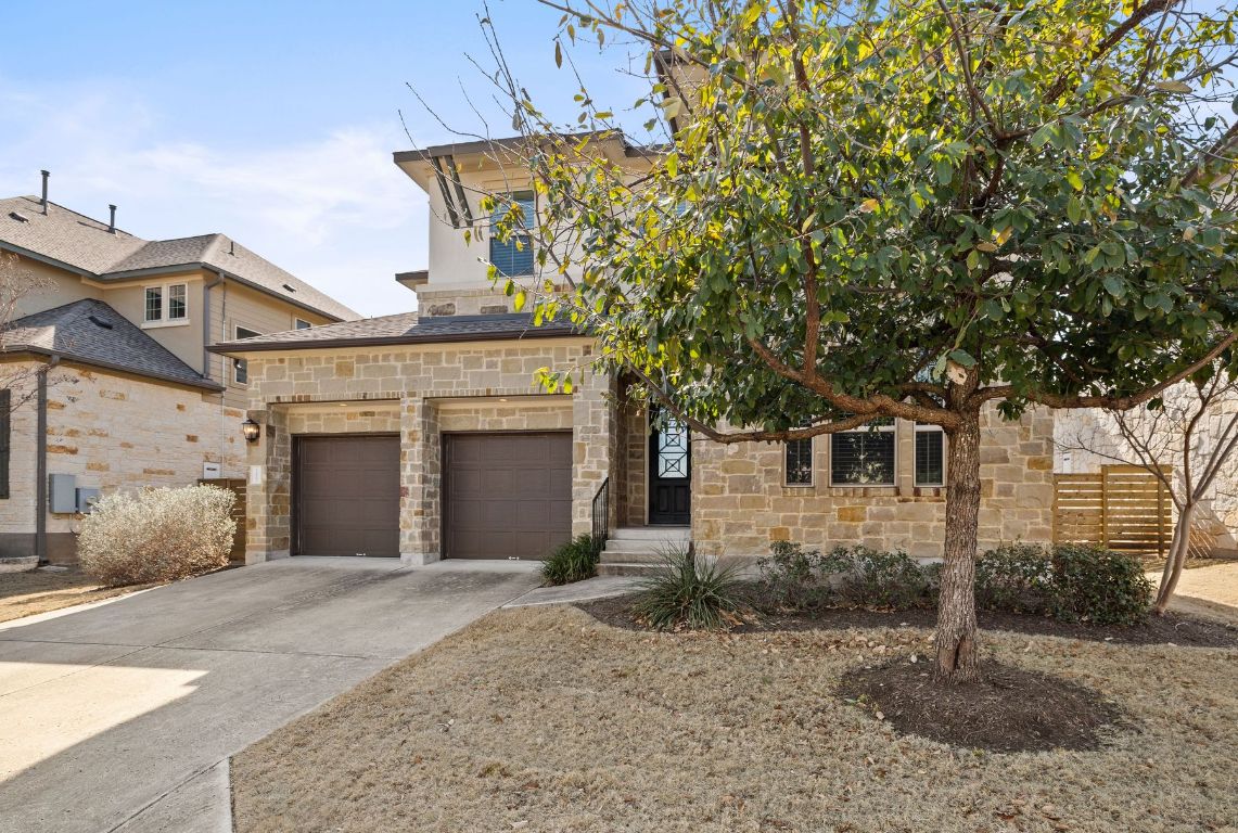 11003 Cut Plains Loop Austin, TX 78726 - Photo 1 of 35 a front view of a house with a yard and garage