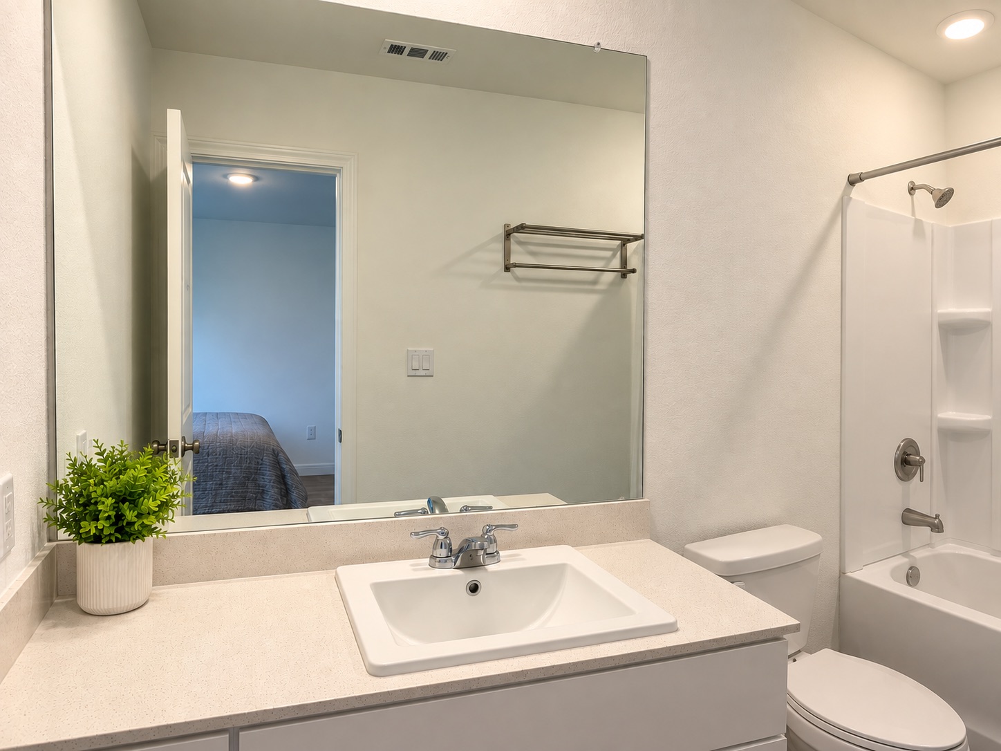 14409 Treyvon Road Manor, TX 78653 - Photo 9 of 21 An integrated vanity countertop and a combined tub and shower unit complete this classic primary bathroom.