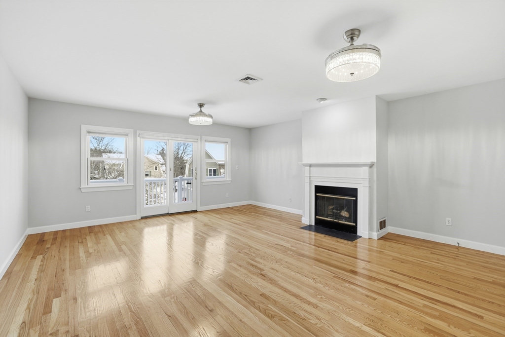 74 Branch Street, Unit 15 Scituate, MA 02066 - Photo 7 of 26 an empty room with windows and fireplace