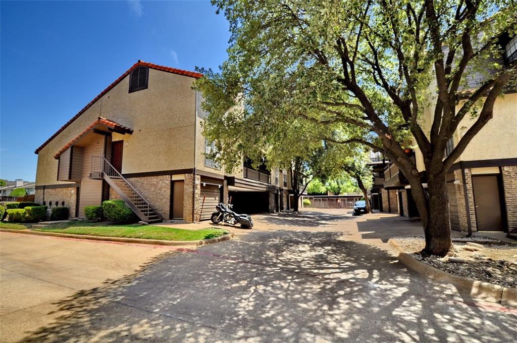 5630 Spring Valley Road, Unit 17A Dallas, TX 75254 - Photo 2 of 14 a front view of a house with a yard and garage