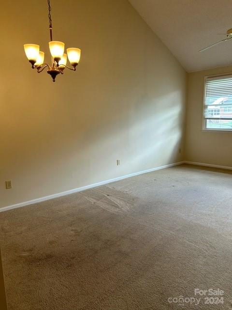 19940 Oak Leaf Circle Cornelius, NC 28031 - Photo 3 of 21 an empty room with a chandelier fan and windows