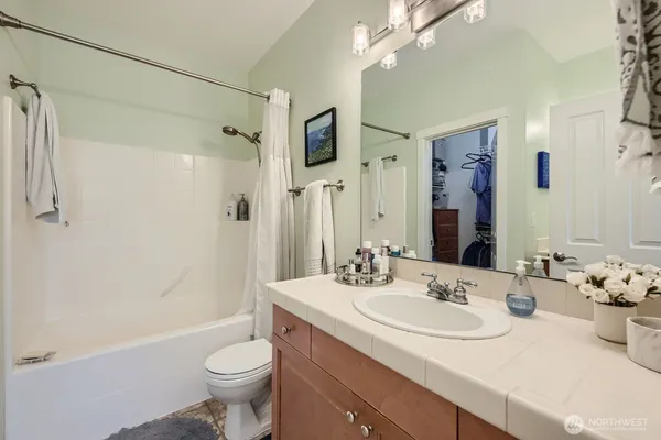 a bathroom with a sink toilet tub and shower