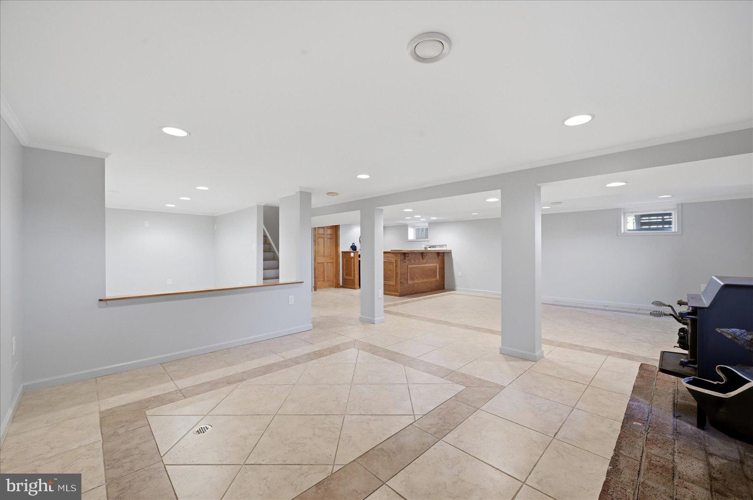 3093 Old Leetown Pike Ranson, WV 25438 - Photo 56 of 85 Custom Tiles basement with wood stove and wet bar
