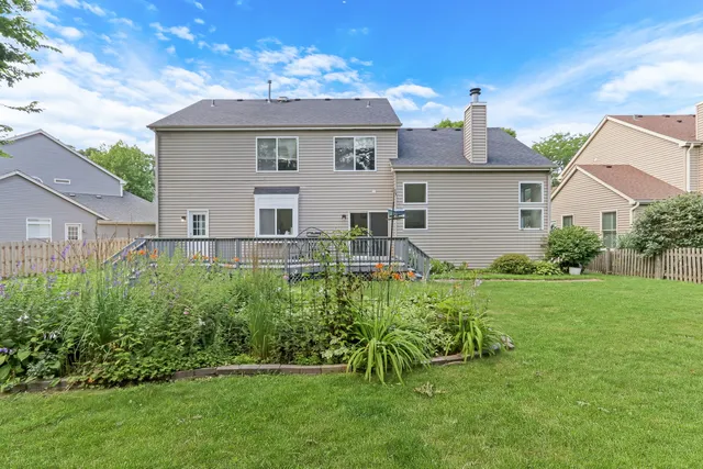 an aerial view of multiple houses with yard