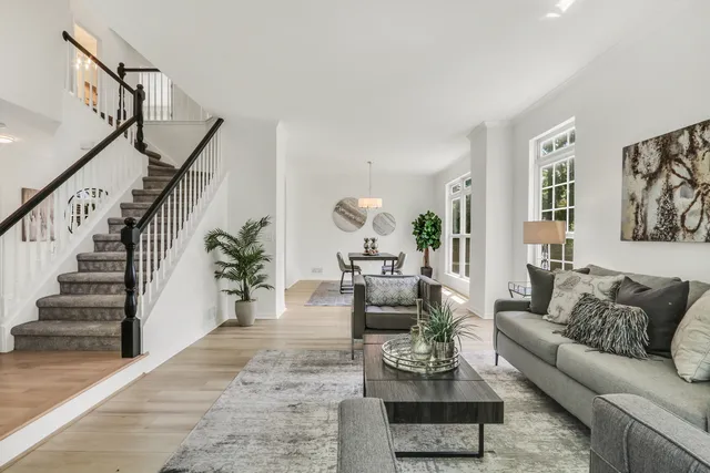 a view of a dining room with furniture wooden floor and chandelier
