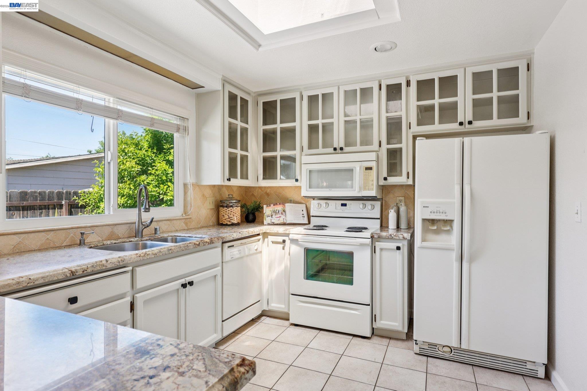 1113 Tokay Common Livermore, CA 94550 - Photo 12 of 30 a kitchen with stainless steel appliances granite countertop a stove a sink and a refrigerator