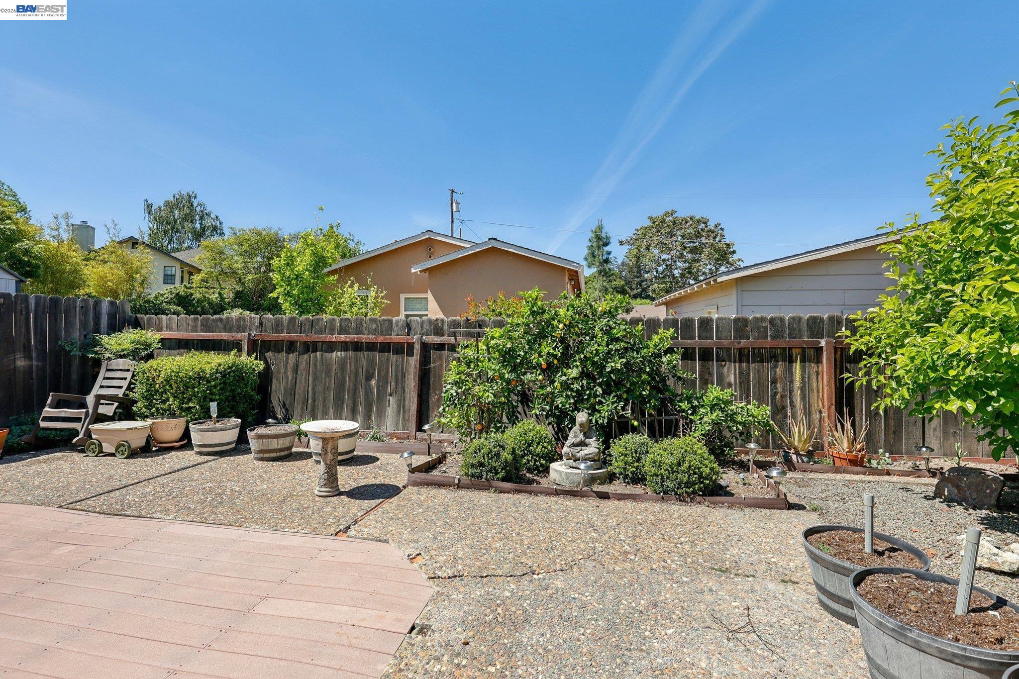 1113 Tokay Common Livermore, CA 94550 - Photo 27 of 30 a view of a patio with a table and chairs under an umbrella