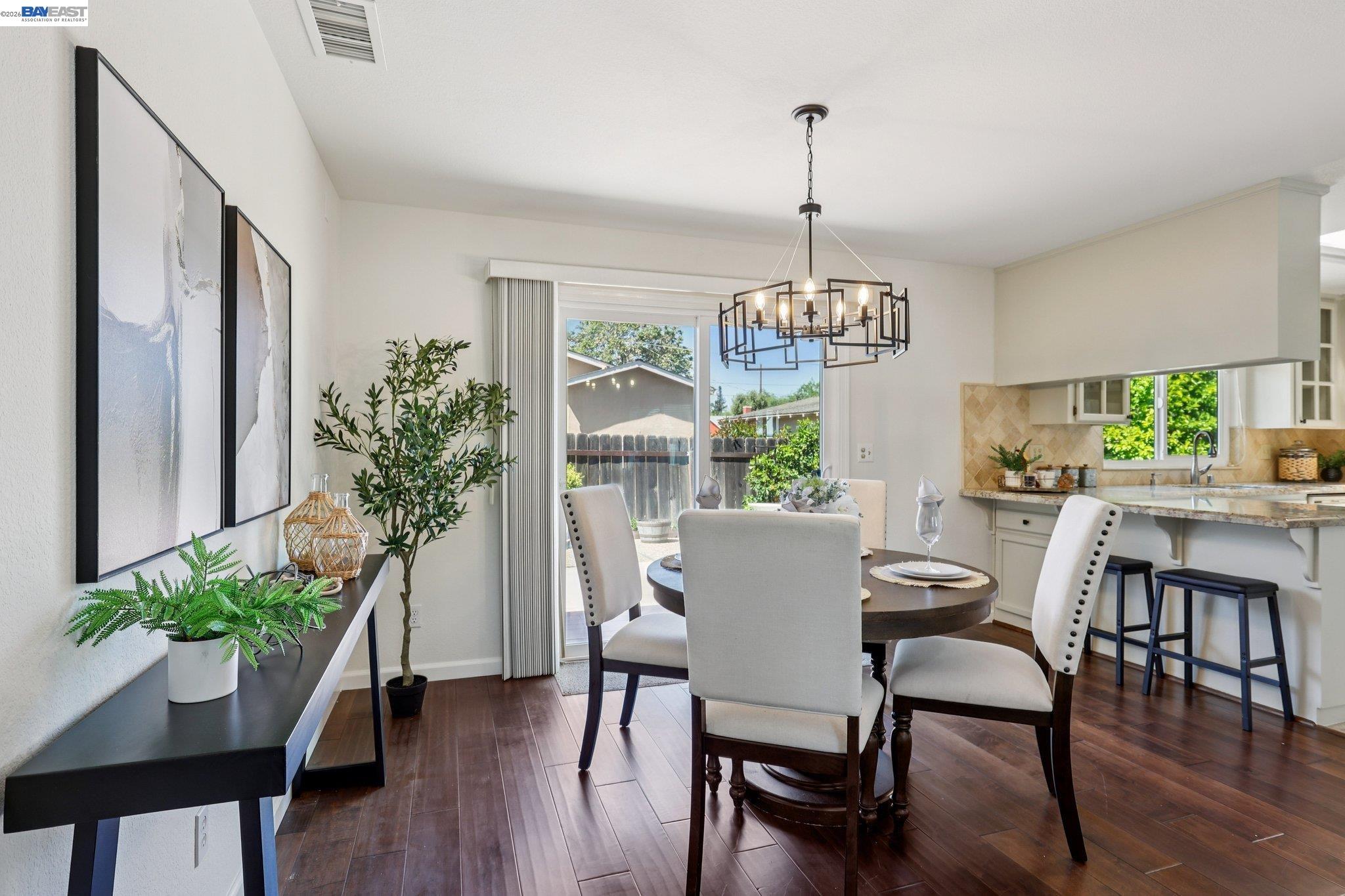 1113 Tokay Common Livermore, CA 94550 - Photo 10 of 30 a dining room with furniture potted plants and wooden floor