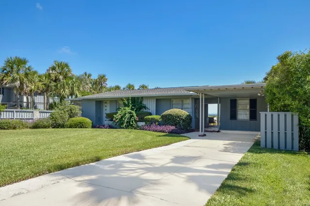a front view of a house with a yard and porch