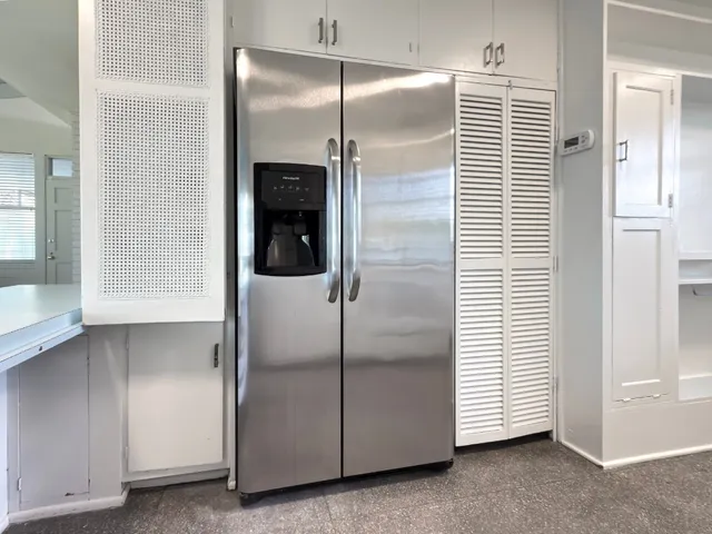 a kitchen with a refrigerator and a sink