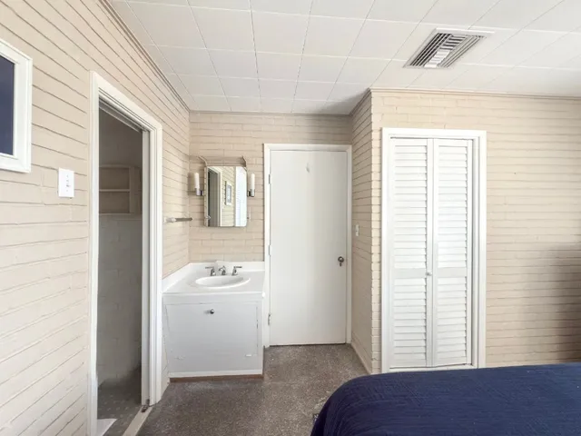 a bedroom with a bed and a mirror