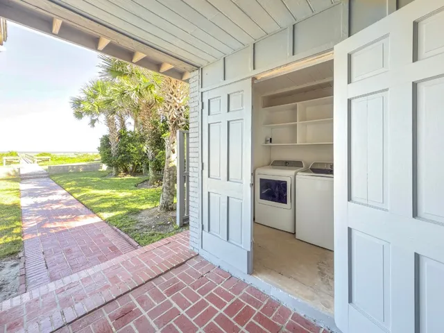 a front view of a house with garden and trees