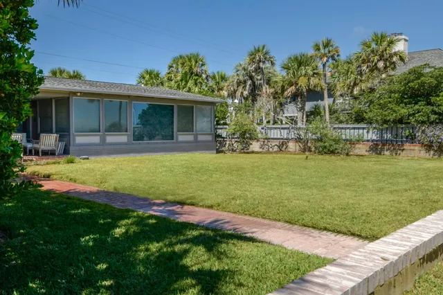 a view of a house with a yard and sitting area